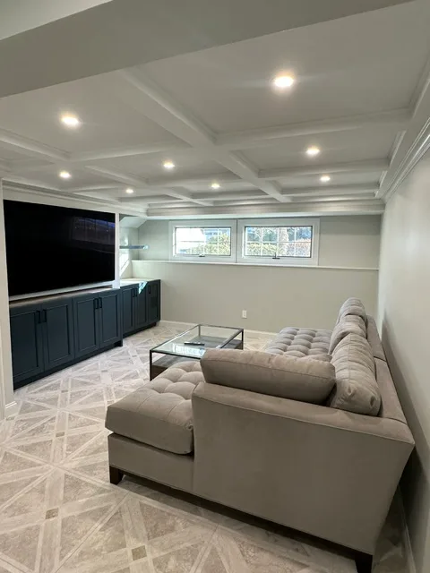 Basement remodel with coffered ceiling and built-ins by Elite Construction Group