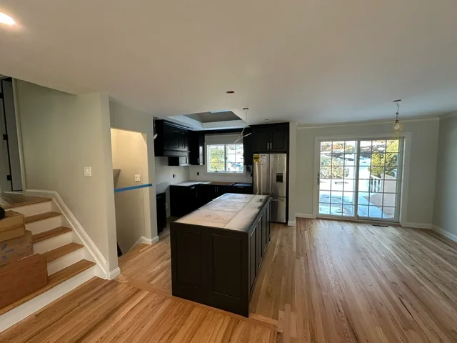 Open kitchen and living space remodeled by Elite Construction Group