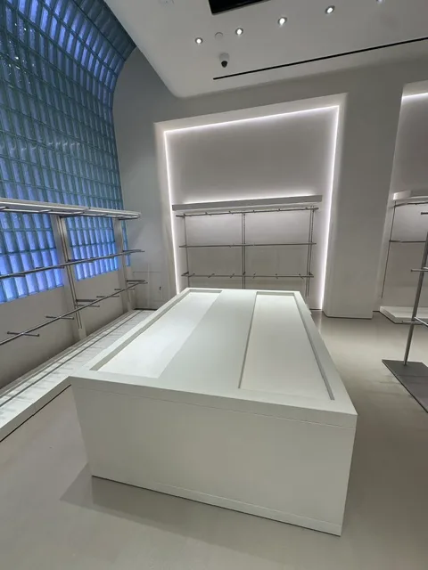 Retail display table and glass-block wall in a commercial interior by Elite Construction Group